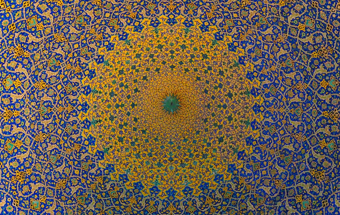 A radial fractal radiating from a bright golden core into intricate blue self-similar fronds.